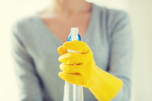 Cleaning technician using protective equipment while working indoors