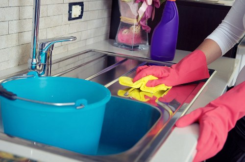 Cleaner maintaining a kitchen and living space in Twickenham